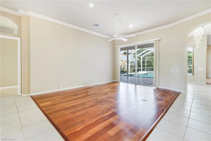 Formal Living Room with Santos Mahogany hardwood / wood-style floors, ceiling fan, and ornamental molding