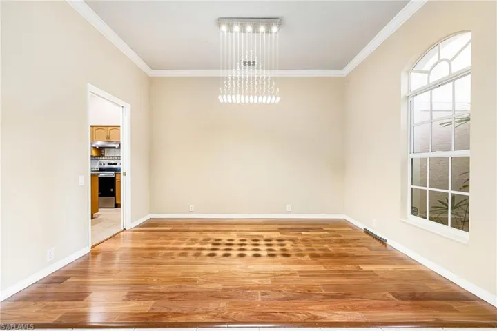 Formal Dining Room featuring a  Crystal chandelier, crown molding, and  Mahogany Hardwood floors