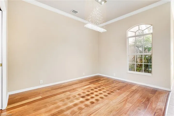 Formal Dining Room featuring a  Crystal chandelier, crown molding, and  Mahogany Hardwood floors