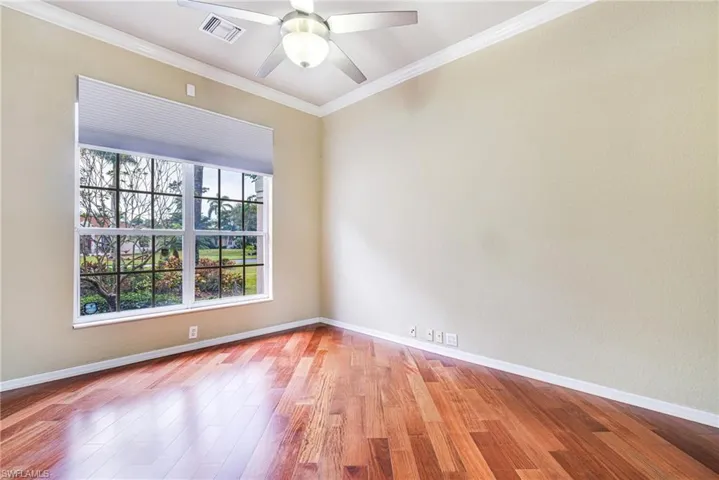 Den or Study with Santos Mahogany flooring, French Doors, ceiling fan, and crown molding