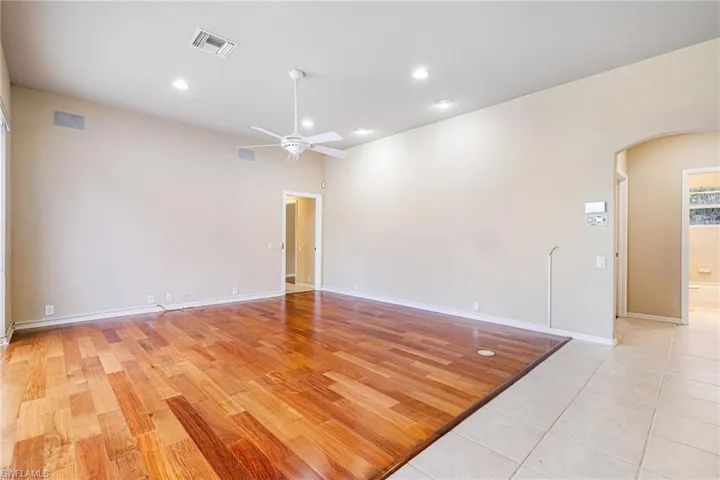 Great room  (unstaged) with Mahogany flooring and ceiling fan