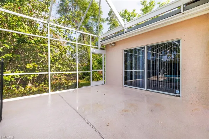 View of patio and lanai door leads to a wonderful and private side yard