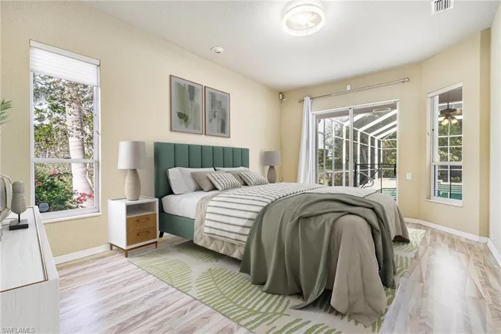 Virtually Staged Master Bedroom with access to Lanai and light wood-type flooring