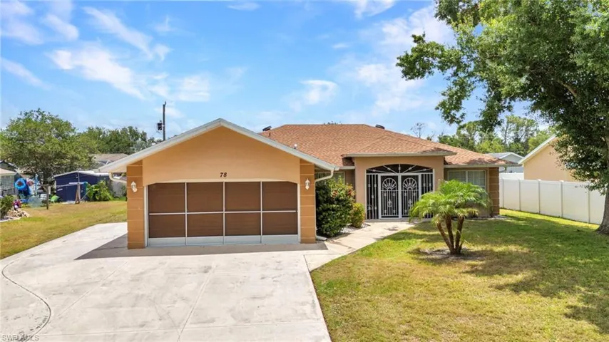 View of front of property featuring concrete driveway, a garage, and stucco siding