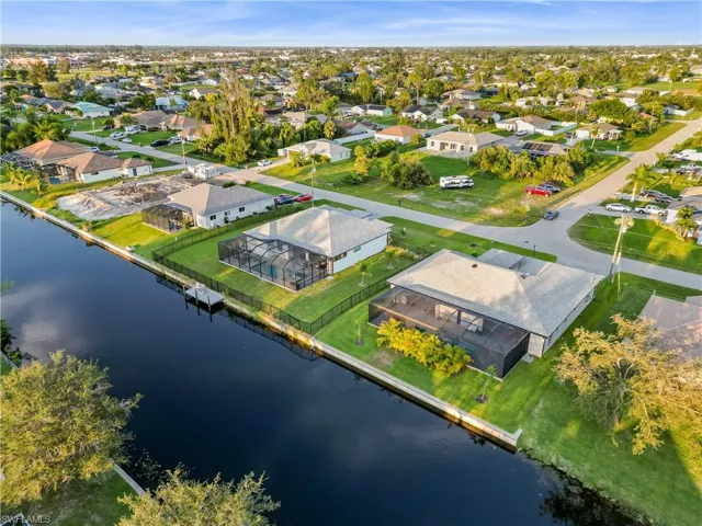 Birds eye view of property with a water view