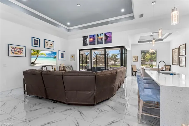 Living room adjacent to kitchen and dining rooms.