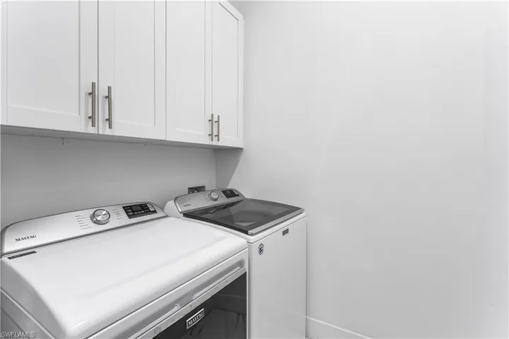 Laundry area featuring cabinets and independent washer and dryer.