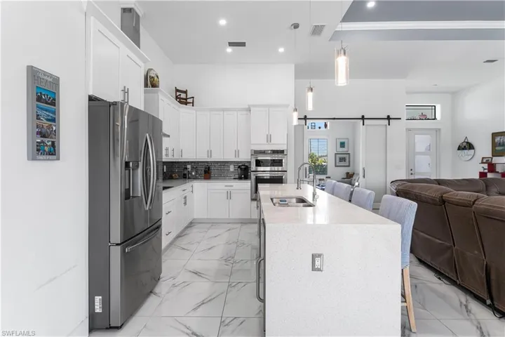 Kitchen featuring a breakfast bar, stainless steel appliances, and a center island.
