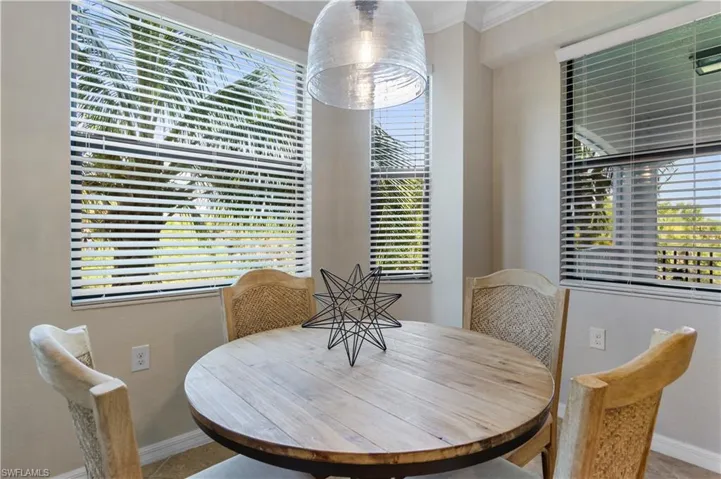 Dining room featuring ornamental molding and tile patterned floors