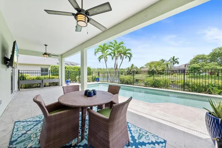 View of patio / terrace featuring ceiling fan and a fenced in pool