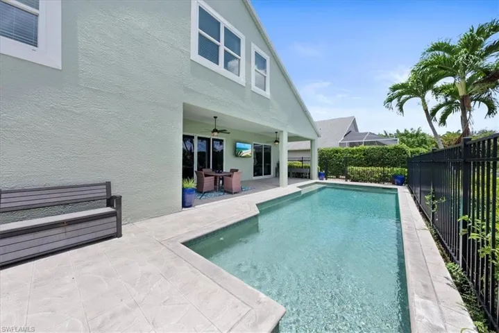View of pool featuring a patio area and ceiling fan