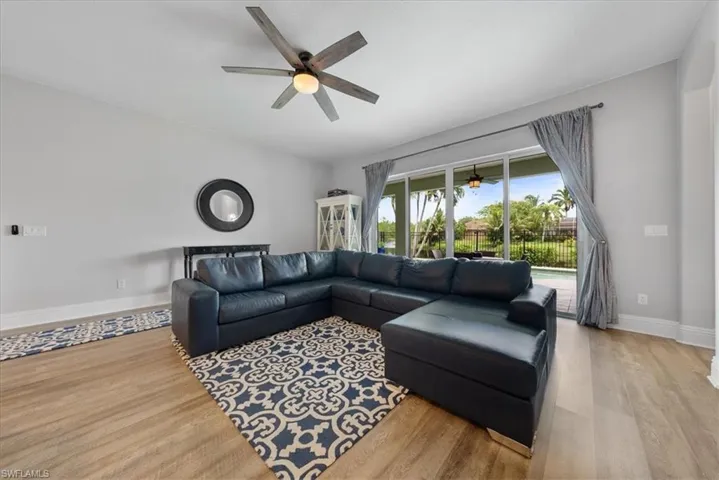 Living room featuring ceiling fan and light hardwood / wood-style flooring