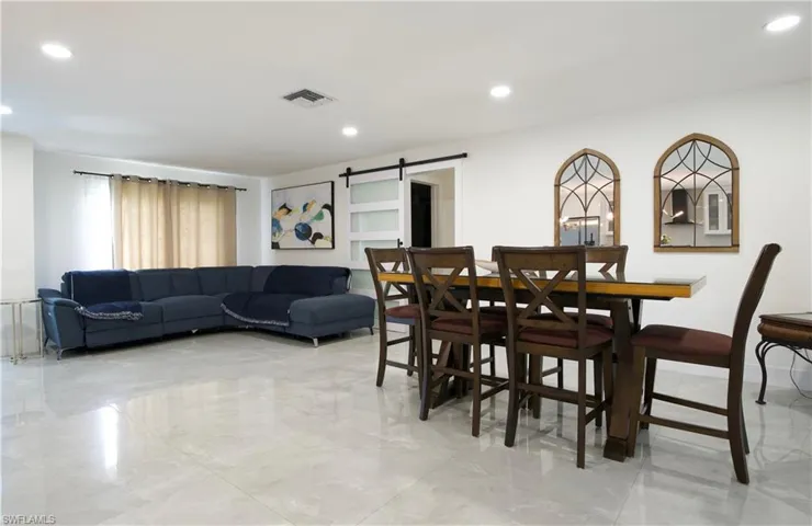 Dining space featuring a barn door and recessed lighting