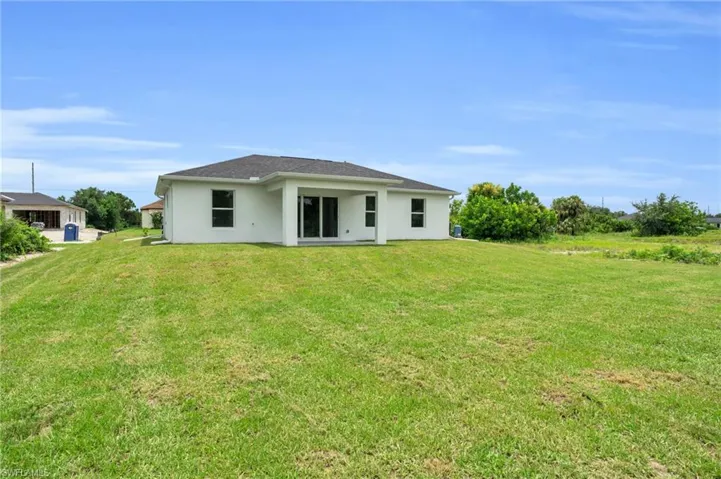 Back of property with a yard