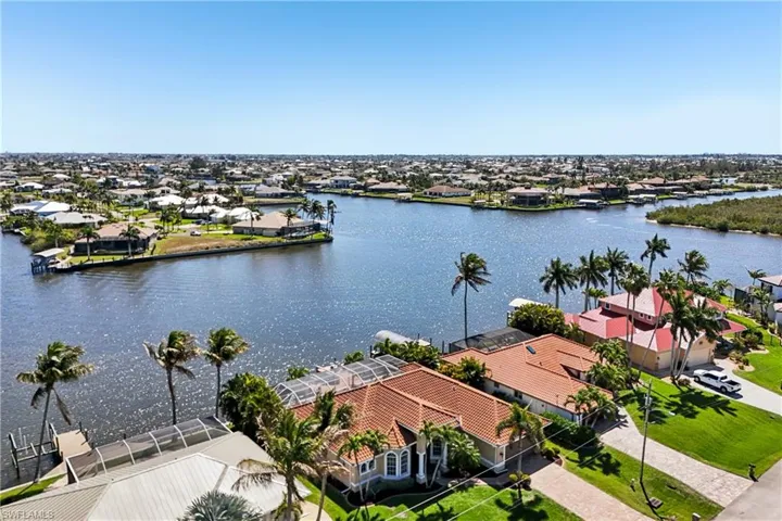 Aerial perspective of suburban area featuring a large body of water