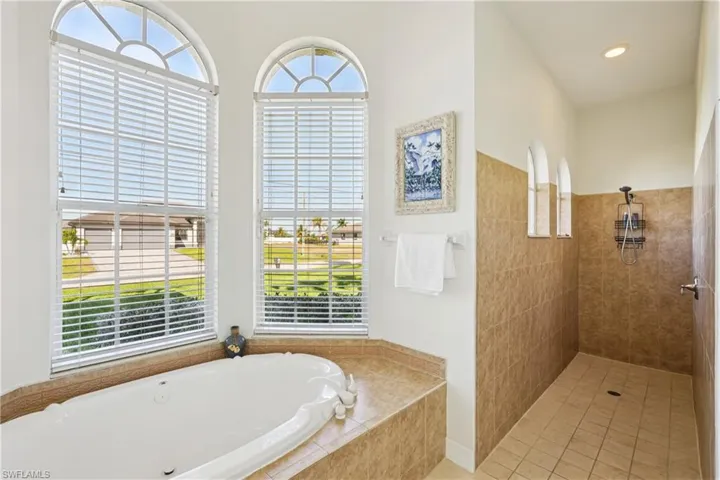 Bathroom featuring a walk in shower and a garden tub