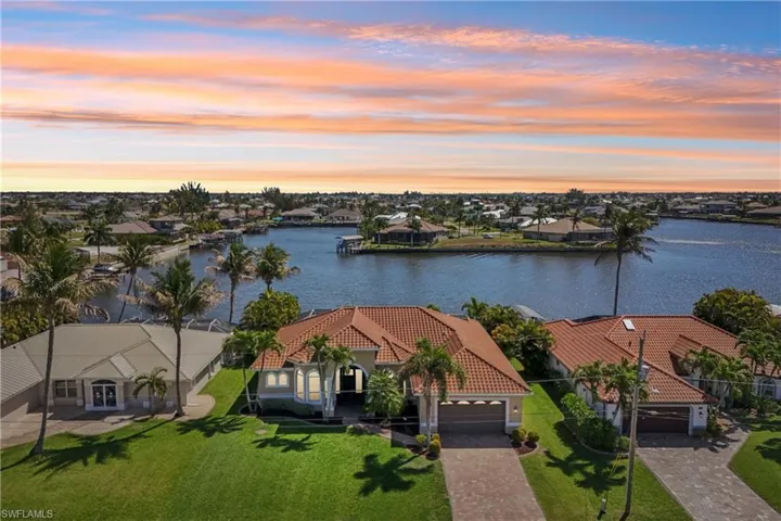 Aerial view at dusk of a water view and a residential view