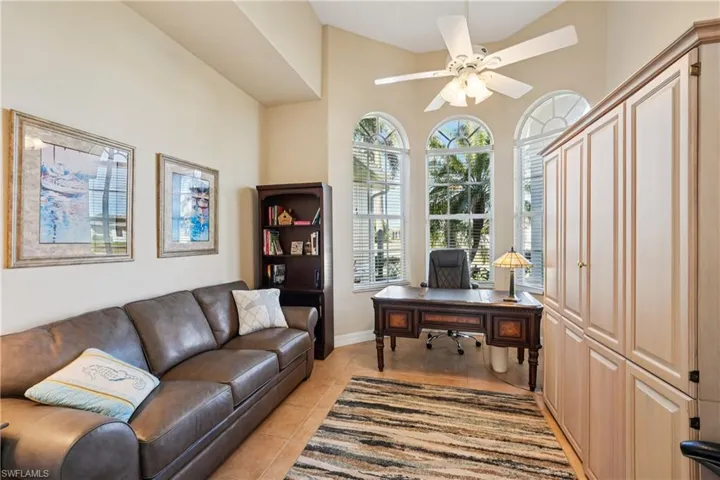 Home office with a ceiling fan and light tile patterned floors