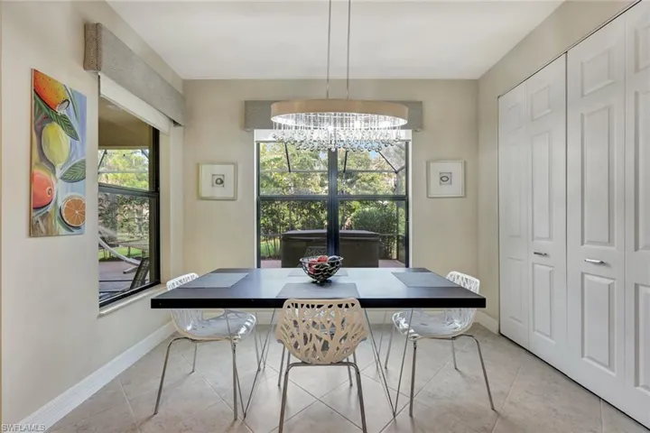 Spacious kitchen dining area seamlessly blending style and functionality, featuring ample room for a large dining table, modern lighting, and scenic views, perfect for casual family meals or hosting gatheringDining space with light tile patterned floors and an inviting chandelier