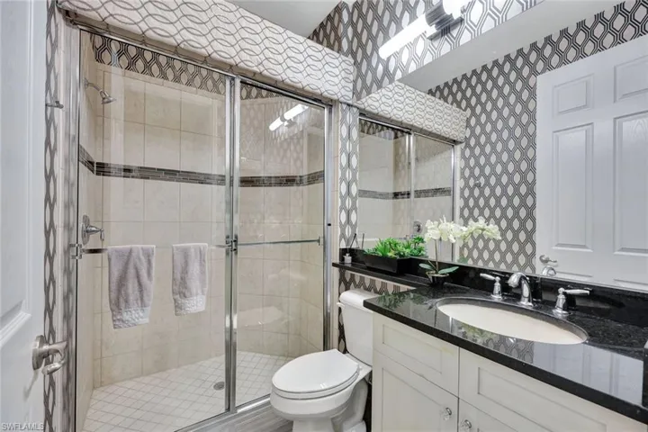 Bathroom with vanity, toilet, and walk in shower
