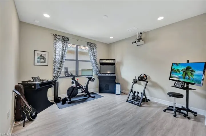 Experience the ultimate in luxury and versatility with your private movie, game, music, and exercise room. This thoughtfully designed space features a built-in large-screen projector, with premium surround sound, and a versatile room that  setup for enjoying your favorite tunes. A discreet closet includes a mini fridge and ample storage for all your audio and video components, ensuring a clean and organized look. With space for a dedicated exercise area, this multifunctional retreat.