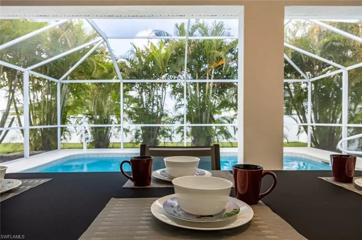 Outdoor pool with a sunroom, a lanai, and a patio area