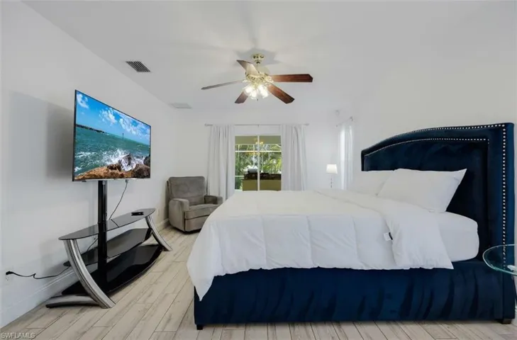 Bedroom with light wood finished floors and a ceiling fan