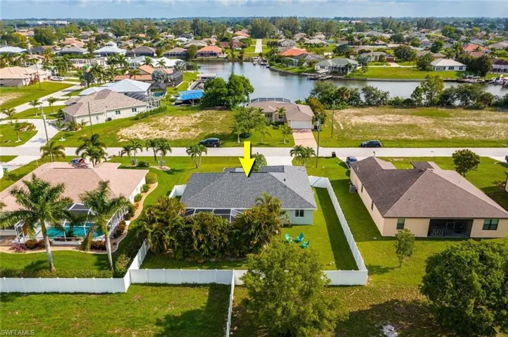 Aerial perspective of suburban area with a nearby body of water