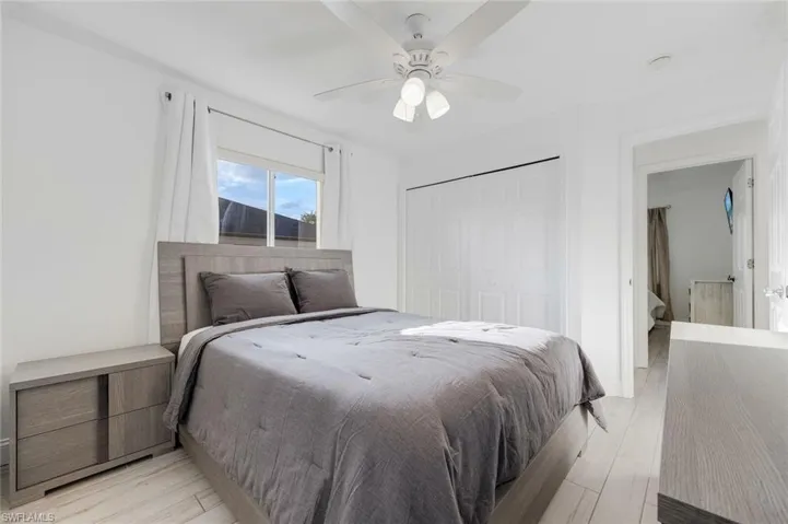 Bedroom featuring a closet, ceiling fan, and light wood-style flooring