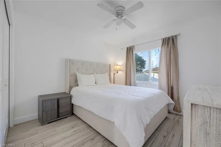 Bedroom featuring light wood-style floors, a ceiling fan, and a closet