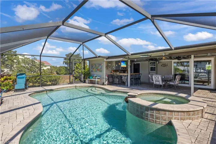 Expansive lanai with water views, perfect for sunset watching, outdoor dining, or enjoying the Florida lifestyle.