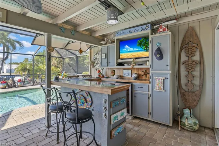 Your private waterfront retreat with sparkling pool, spa, and a poolside bar ready for entertaining.