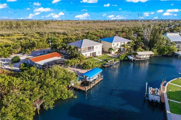 Aerial capture of the backyard with pool, spa, and dock offering effortless boating and water activities.