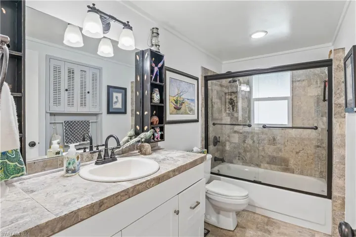 Spacious guest bathroom featuring a full tub/shower combination.