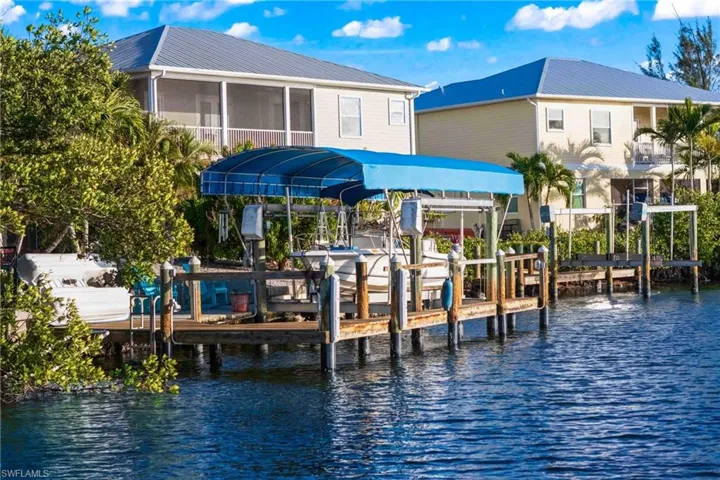 Brand-new dock with captain’s walk, lift canopy (2025), and 10,000 lb. covered boat lift—ready for effortless access to open water.