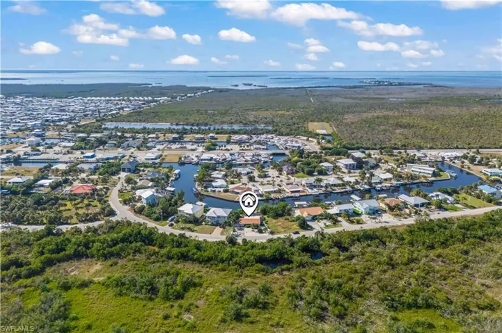 Bird’s-eye view emphasizing the home’s tropical landscaping, water access, and private retreat feel.