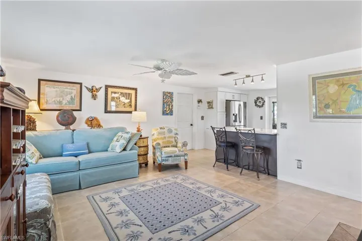 Spacious living area featuring oversized pocket sliding doors, providing serene water views and a dramatic connection to the outdoor oasis.