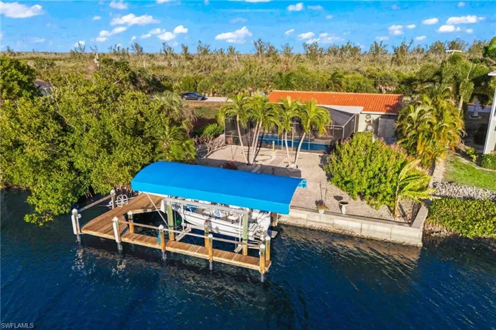 Aerial view showcasing the expansive backyard, dock, and unobstructed nature preserve across the water.
