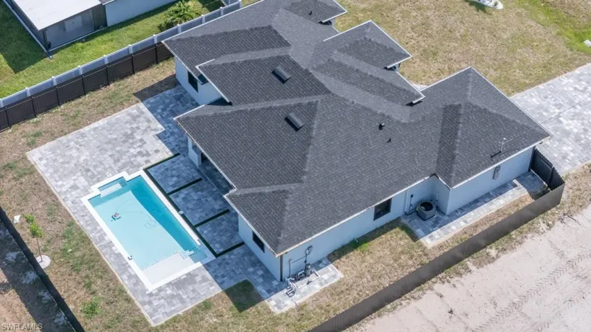 View of subject property featuring a pool