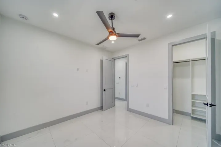 Unfurnished bedroom with recessed lighting, baseboards, ceiling fan, and a closet
