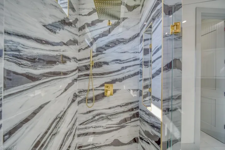 Bathroom featuring a marble finish shower