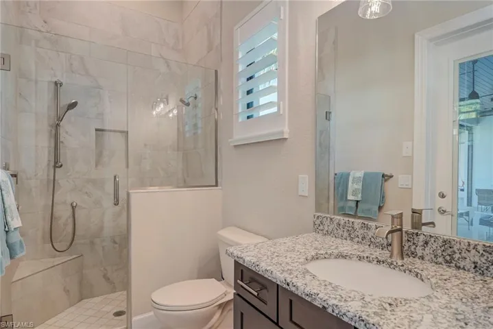 Bathroom with vanity and a shower stall