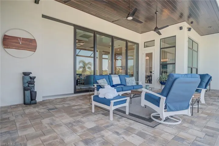 View of patio with ceiling fan and an outdoor hangout area