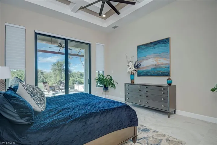 Bedroom featuring coffered ceiling, beamed ceiling, access to exterior, a towering ceiling, and a ceiling fan