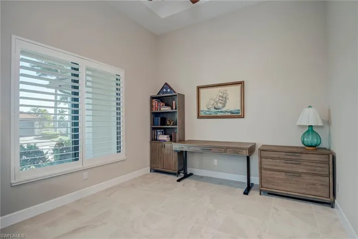 Home office featuring ceiling fan and light tile patterned flooring