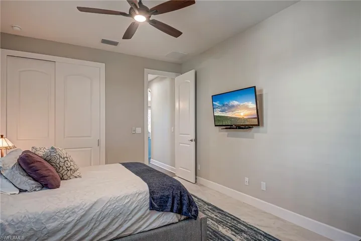 Bedroom with ceiling fan and a closet