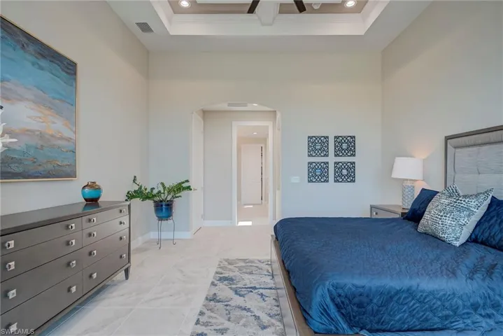 Bedroom with arched walkways, recessed lighting, and a ceiling fan