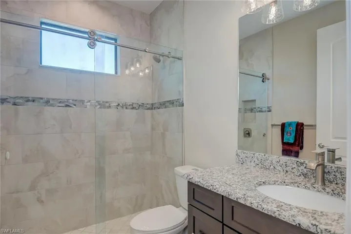 Bathroom featuring vanity and a stall shower