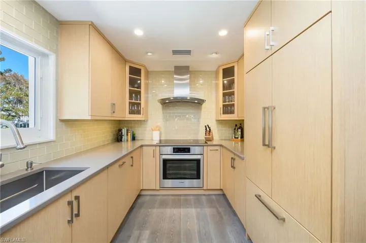 Newly remodeled custom kitchen features integrated cabinetry with custom