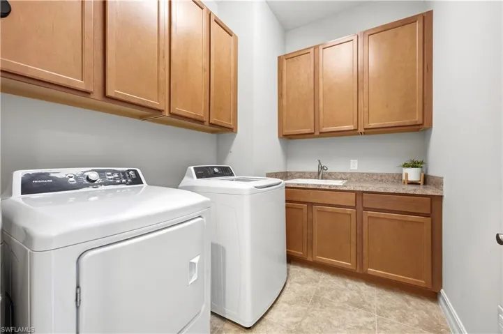 Large Laundry Room with built in cabinets for stragare